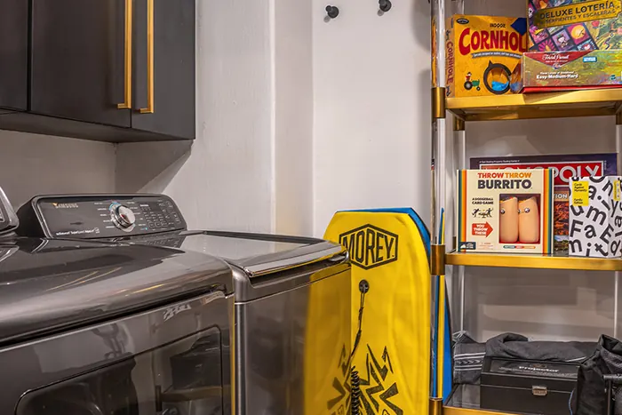 Board games, bodyboards, washer and dryer in the utility room