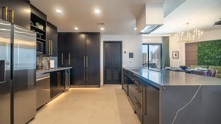 Black and gold kitchen with Samsung refrigerator