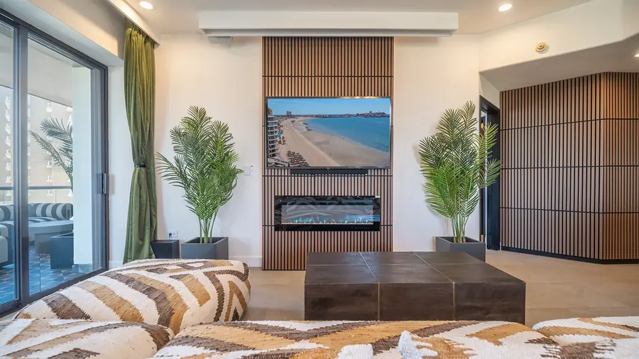 Rubi 208 living room with electric fireplace and 65-inch TV