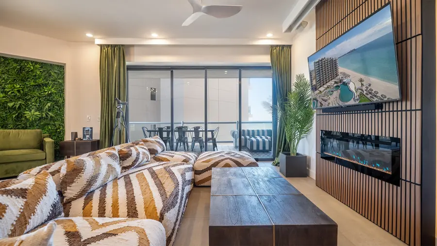 Living room at Rubi 208 with sectional sofa, fireplace and wall-mounted TV