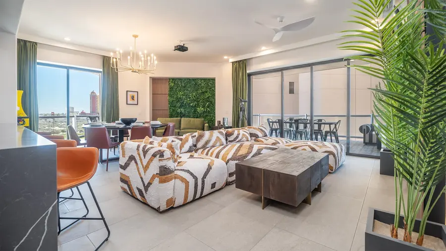 Main living area of Rubi 208 with sectional, dining table and ocean-view windows