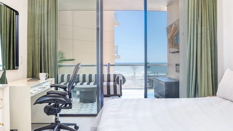 King bed beside sliding doors to the balcony