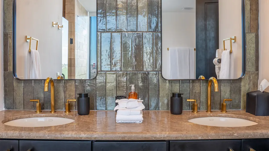 Dual vanity with gold fixtures in Master Suite B