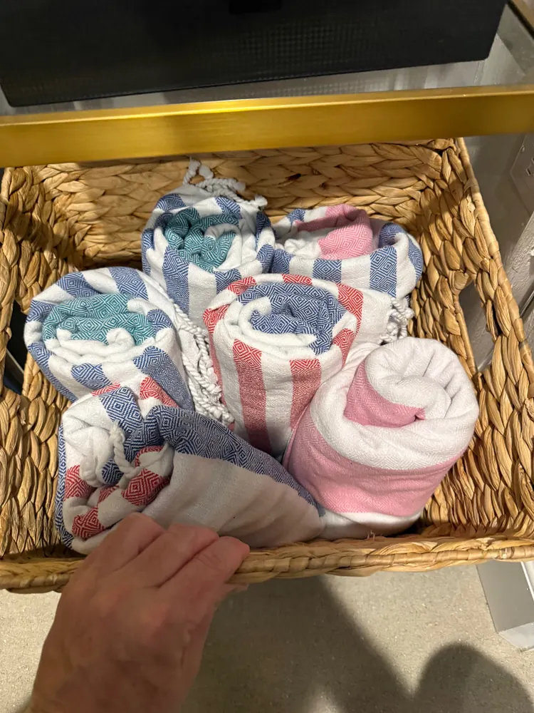 Basket of rolled Turkish beach towels at Rubi 208